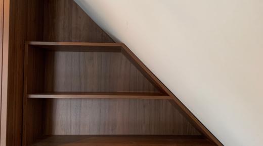 Regal aus dunklem Holzfurnier angepasst an Dachschräge